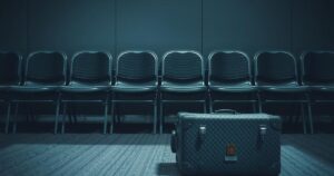 A somber scene depicting empty chairs and a neglected suitcase symbolizing immigration struggles and uncertainty.