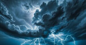 Dramatic stormy sky with dark clouds and lightning over a landscape, showcasing the power of nature's forces.