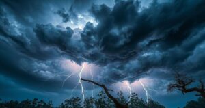 Severe thunderstorm approaching with dark clouds, lightning, and trees bending in strong winds under a dramatic sky.