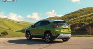 A sleek Toyota Corolla Cross in a serene landscape, surrounded by green hills and blue skies, highlighting its compact SUV design.