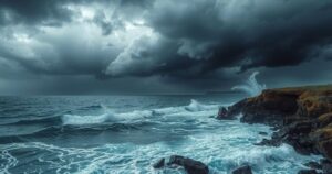 Coastal scene showing dark storm clouds over a seaside with turbulent waves during a tropical storm watch.